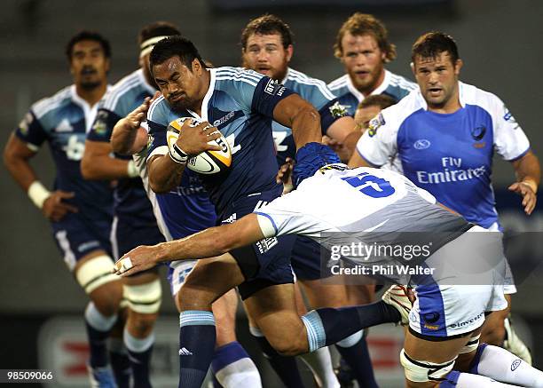 Isaia Toeava of the Blues is tackled by Nathan Sharpe of the Force during the round 10 Super 14 match between the Blues and the Western Force at Eden...