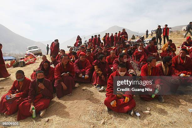 Tibrtan monks pary for vicitm during a fire funeral following a strong earthquake on Jiegu toweship of China's Qinghai province just on April 17,...