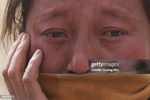 Tibrtan woman cry during a mass cremation for the vicitms following a strong earthquake on Jiegu toweship of China's Qinghai province just on April...