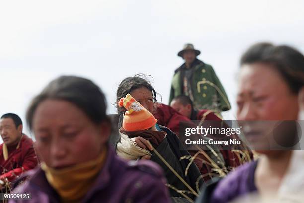 Tibrtan woman reacts during a mass cremation for the vicitms of a strong earthquake on Jiegu toweship of China's Qinghai province just on April 17,...