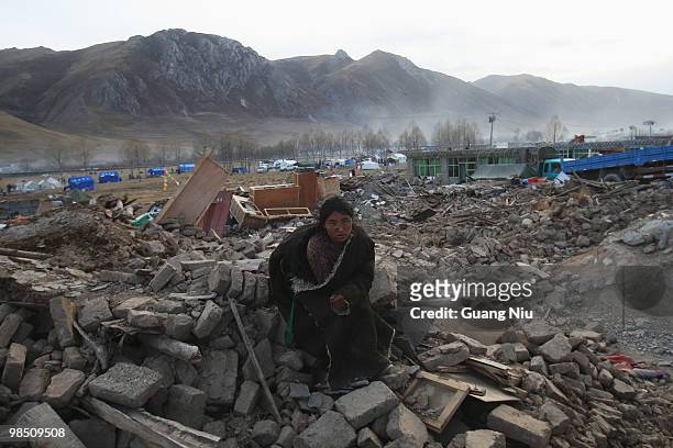 Tibetan women waits for a help during a mass cremation for the victims of a strong earthquake, on April 17 in Jiegu, near Golmud, China. Current...