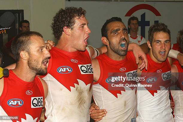 Nick Malceski, Shane Mumford, Adam Goodes and Josh Kennedy of the Swans sing the song in the rooms after winning the round four AFL match between the...