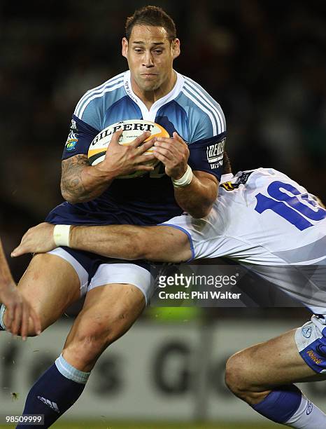 Luke McAlister of the Blues is tackled by David Hill of the Force during the round 10 Super 14 match between the Blues and the Western Force at Eden...