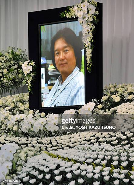 Portrait of slain Japanese journalist Hiroyuki Muramoto is displayed on an altar before the start of his wake at a funeral hall in Tokyo on April 17,...