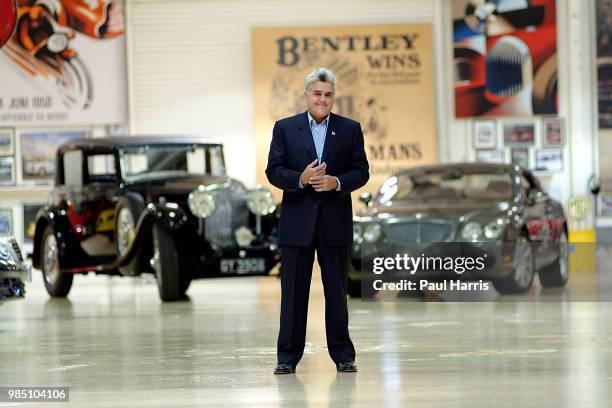 Jay Leno stands in one of his 3 car storage facilities with a 1931 Straight 8 Bentley he owns and a 2004 Bentley S2. American Television personality...