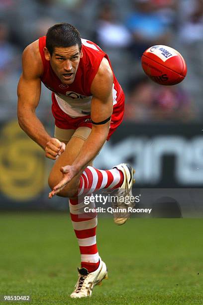 Martin Mattner of the Swans handballs during the round four AFL match between the North Melbourne Kangaroos and the Sydney Swans at Etihad Stadium on...