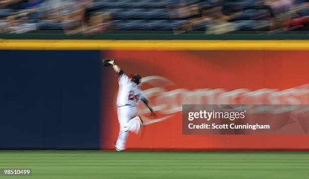 Nate McLouth of the Atlanta Braves makes a running catch against the Colorado Rockies at Turner Field on April 16, 2010 in Atlanta, Georgia. The...