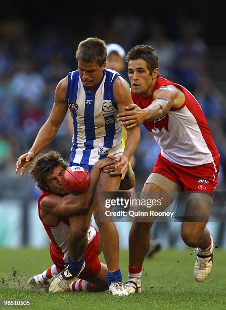 Andrew Swallow of the Kangaroos is tackled by Brett Kirk of the Swans during the round four AFL match between the North Melbourne Kangaroos and the...