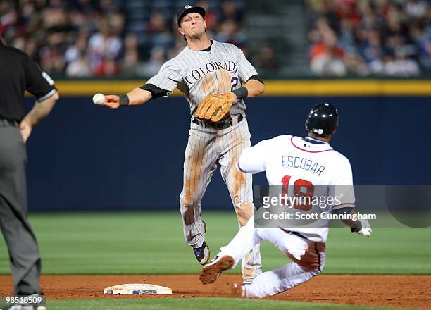 Troy Tulowitzki of the Colorado Rockies turns a double play against the Atlanta Braves at Turner Field on April 16, 2010 in Atlanta, Georgia. The...