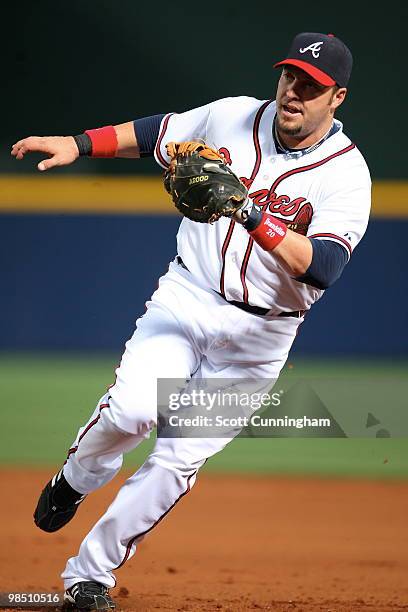 Eric Hinske of the Atlanta Braves fields a grounder against the Colorado Rockies at Turner Field on April 16, 2010 in Atlanta, Georgia. The Braves...