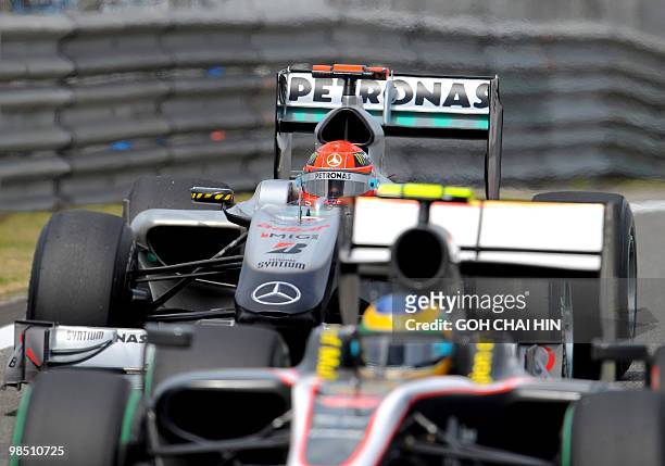 Mercedes GP driver Michael Schumacher of Germany follows the car of Hispania-Cosworth driver Bruno Senna of Brazil into the pits during the final...