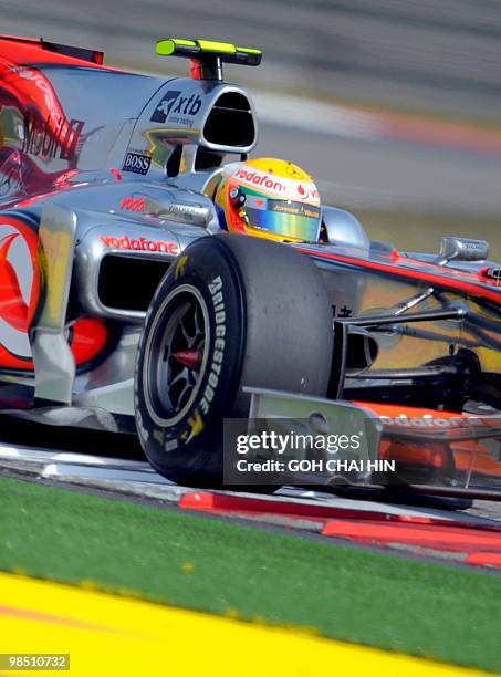 McLaren-Mercedes driver Lewis Hamilton of Britain drives his car during the final qualifying session for Formula One's Chinese Grand Prix in Shanghai...