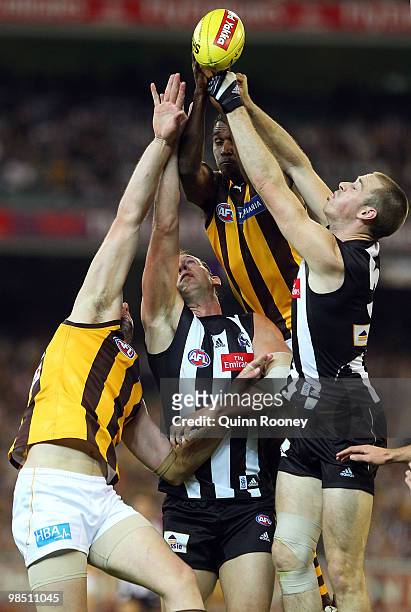 Carl Peterson of the Hawks and Nick Maxwell of the Magpies attempt to punch the ball out of the ruck during the round four AFL match between the...