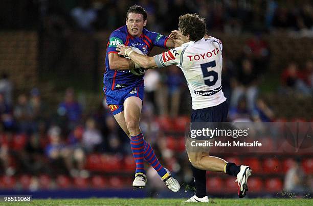 Kurt Gidley of the Knights is tackled by Ashley Graham of the Cowboys during the round six NRL match between the Newcastle Knights and the North...
