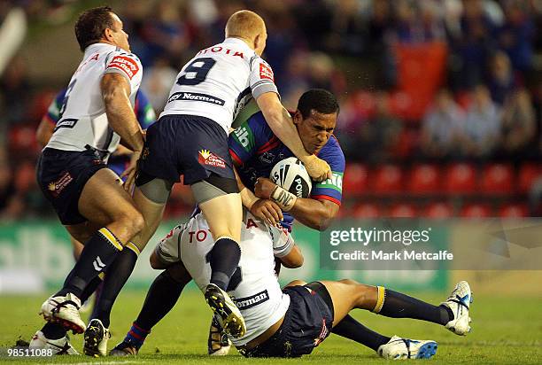 Cooper Vuna of the Knights is tackled during the round six NRL match between the Newcastle Knights and the North Queensland Cowboys at...