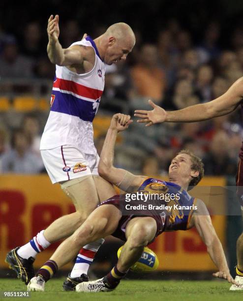 Barry Hall of the Bulldogs is penalised for this challenge on Luke Power during the round four AFL match between the Brisbane Lions and the Western...