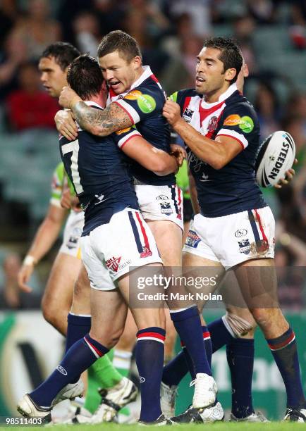 Todd Carney of the Roosters celebrates a try by Shaun Kenny-Dowall with Mitchell Pearce during the round six NRL match between the Sydney Roosters...