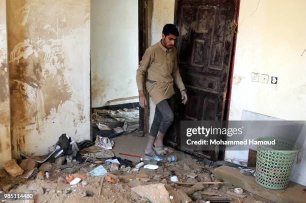 People search for survivors under rubble of a house after it was destroyed by an airstrike of the Saudi-led coalition, that killed eight members of...