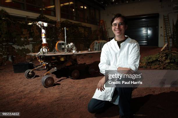 Mars Rover driver Scott A Maxwell in the test hanger with a full scale working Mars Rover, with a computer terminal he tests the movements of this...