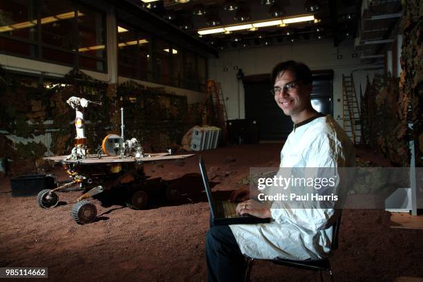 Mars Rover driver Scott A Maxwell in the test hanger with a full scale working Mars Rover, with a computer terminal he tests the movements of this...