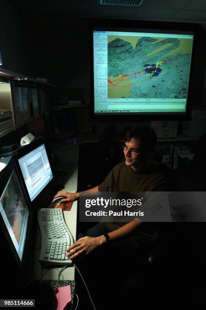 Mars Rover driver Scott A Maxwell in the test hanger with a full scale working Mars Rover, with a computer terminal he tests the movements of this...