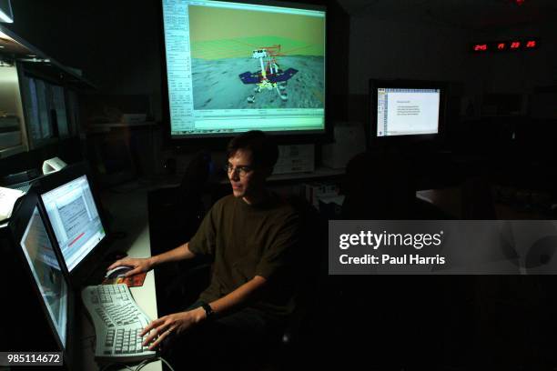 Mars Rover driver Scott A Maxwell in the test hanger with a full scale working Mars Rover, with a computer terminal he tests the movements of this...