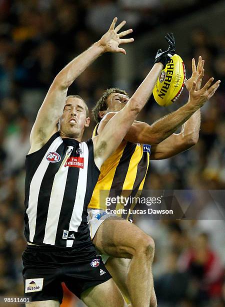 Nick Maxwell of the Magpies attempts a mark against Campbell Brown of the Hawks during the round four AFL match between the Collingwood Magpies and...