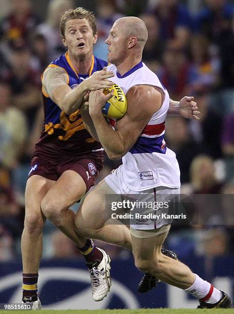 Barry Hall of the Bulldogs is tackled by Troy Selwood of the Lions during the round four AFL match between the Brisbane Lions and the Western...