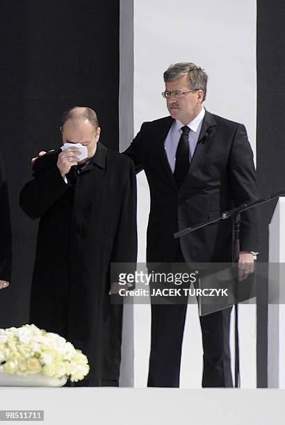 Maciej Lopinski , Director of the Presidential cabinet is comforted by Poland's acting President Bronislaw Komorowski as they attend with Polish...