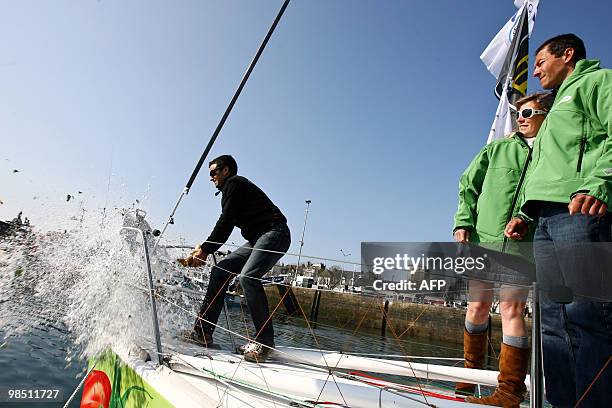 French yachtsman Franck Cammas, winner of the Jules Verne Trophy, christens the monohull "Saveol" skipped by Romain Attanasio and Samantha Davies on...