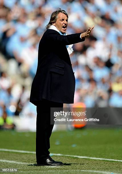 Manchester City Manager Roberto Mancini issues instructions during the Barclays Premier League match between Manchester City and Manchester United at...