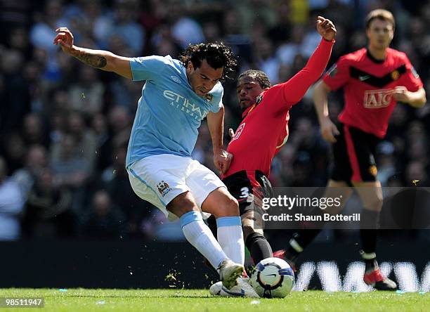 Carlos Tevez of Manchester City is tackled by Patrice Evra of Manchester United during the Barclays Premier League match between Manchester City and...