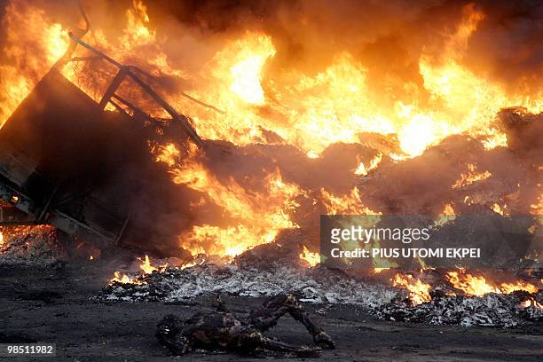 Burnt body lies beside fuel tankers and truck in flames at Ibafo, Ogun State on Lagos Ibadan Highway early hours on April 17, 2010. Two tankers...