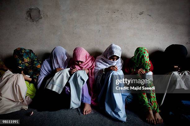 Afghan women learn how to embroid at a workshop sponsored by a Malaysian NGO called Mercy that seeks to help local females to empower themselves, on...