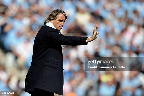 Manchester City Manager Roberto Mancini issues instructions during the Barclays Premier League match between Manchester City and Manchester United at...