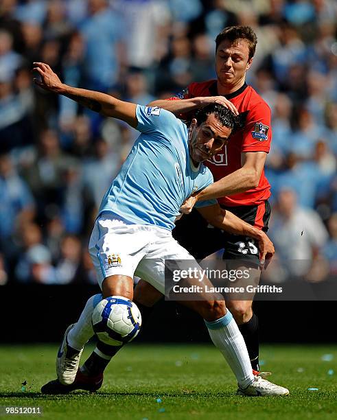 Carlos Tevez of Manchester City battles for the ball with Jonny Evans of Manchester United during the Barclays Premier League match between...