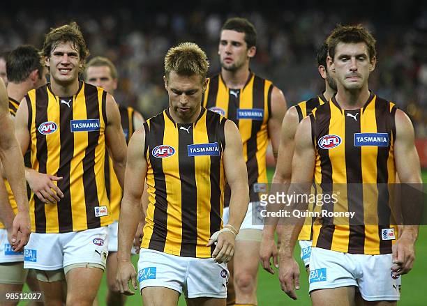 Sam Mitchell and his Hawks players look dejected as they leave the field after losing the round four AFL match between the Collingwood Magpies and...