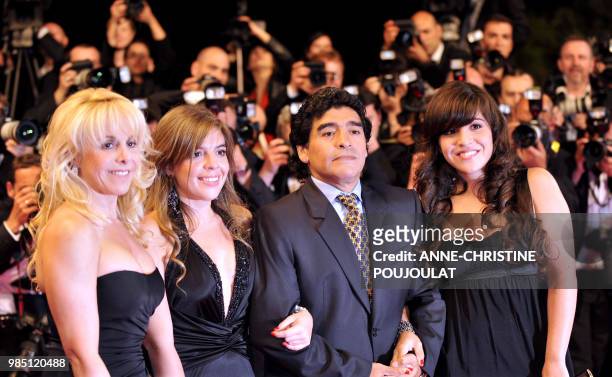 Former Argentinian football player Diego Maradona poses as he arrive with his wife Claudia and daughters Dalma and Giannina to attend the screening...