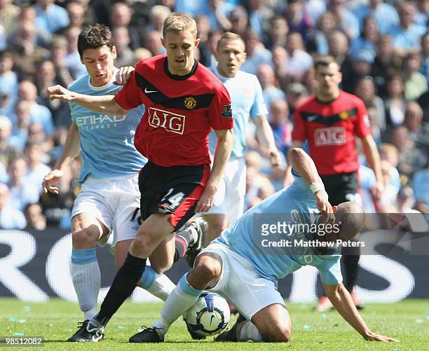 Darren Fletcher of Manchester United clashes with Gareth Barry and Nigel De Jong of Manchester City during the Barclays Premier League match between...