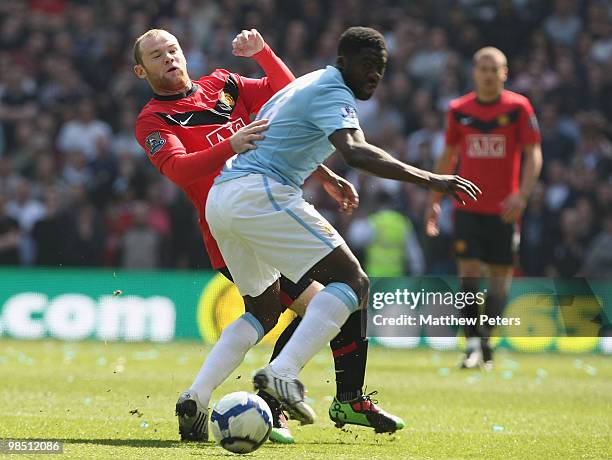 Wayne Rooney of Manchester United clashes with Kolo Toure of Manchester City during the Barclays Premier League match between Manchester City and...