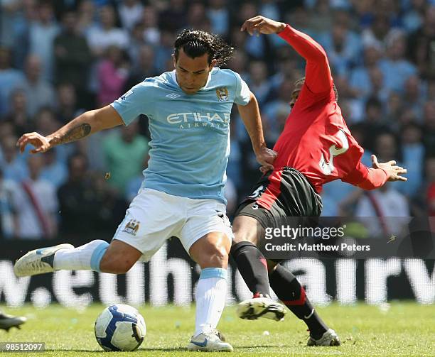 Patrice Evra of Manchester United clashes with Carlos Tevez of Manchester City during the Barclays Premier League match between Manchester City and...