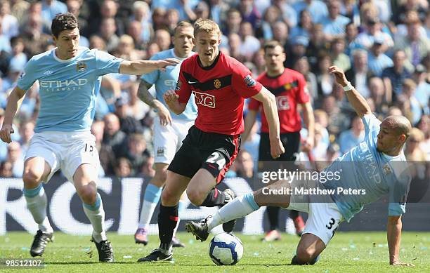 Darren Fletcher of Manchester United clashes with Gareth Barry and Nigel De Jong of Manchester City during the Barclays Premier League match between...