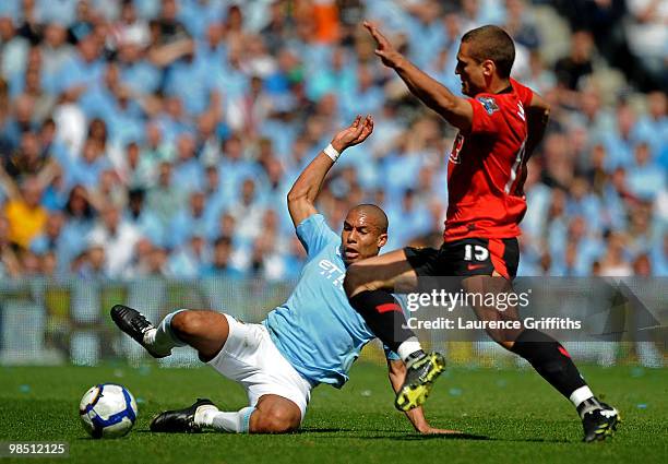 Nigel de Jong of Manchester City competes for the ball with Nemanja Vidic of Manchester United during the Barclays Premier League match between...