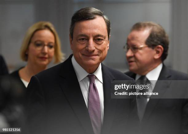 Mario Draghi , president of the European Central Bank , his deputy Vitor Constancio and head of communications Christine Graeff walking to their...