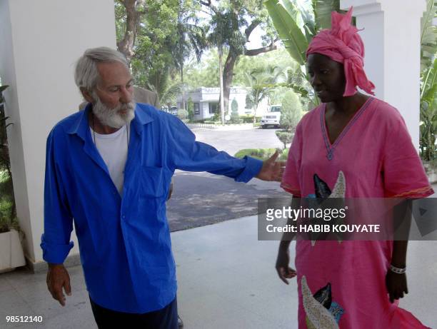 Sergio Cicala of Italy, and his Italian-Burkinabe wife Philomene Kaboure walk together on April 17, 2010 at the Presidential Palace in Bamako prior...