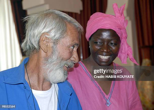 Sergio Cicala of Italy, and his Italian-Burkinabe wife Philomene Kaboure smile on April 17, 2010 at the Presidential Palace in Bamako prior to a...