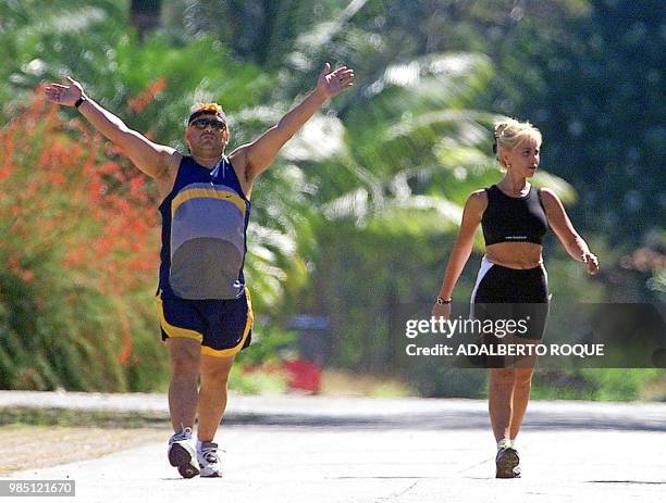 Former Argentine soccer star Diego Armando Maradona and his wife Claudia Villafane go for a walk in the garden of the Hotel Las Praderas 22 January...