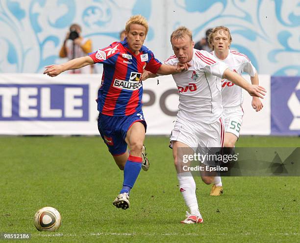 Keisuke Honda of PFC CSKA Moscow battles for the ball with Denis Glushakov of FC Lokomotiv Moscow during the Russian Football League Championship...