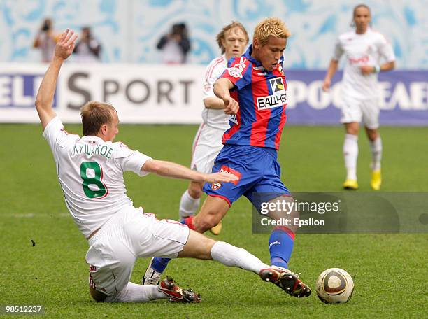 Keisuke Honda of PFC CSKA Moscow battles for the ball with Denis Glushakov of FC Lokomotiv Moscow during the Russian Football League Championship...