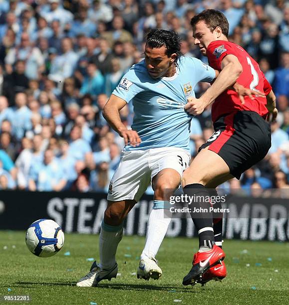 Jonny Evans of Manchester United clashes with Carlos Tevez of Manchester City during the Barclays Premier League match between Manchester City and...